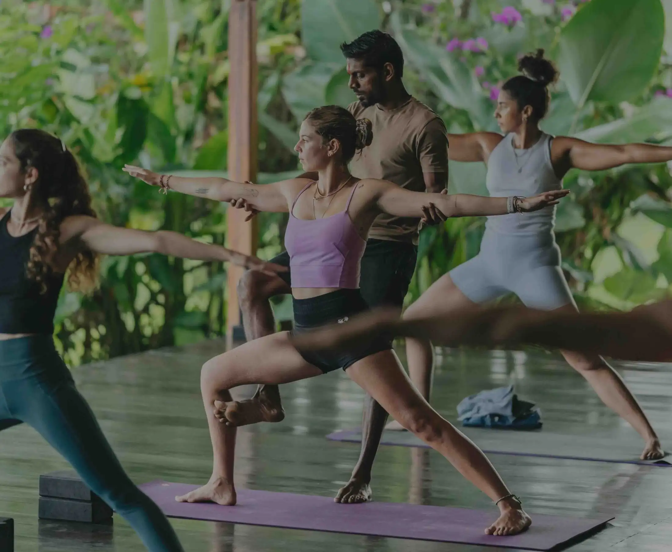 Students holding warrior II in the open shala during the Ashtanga intensive at Senses
